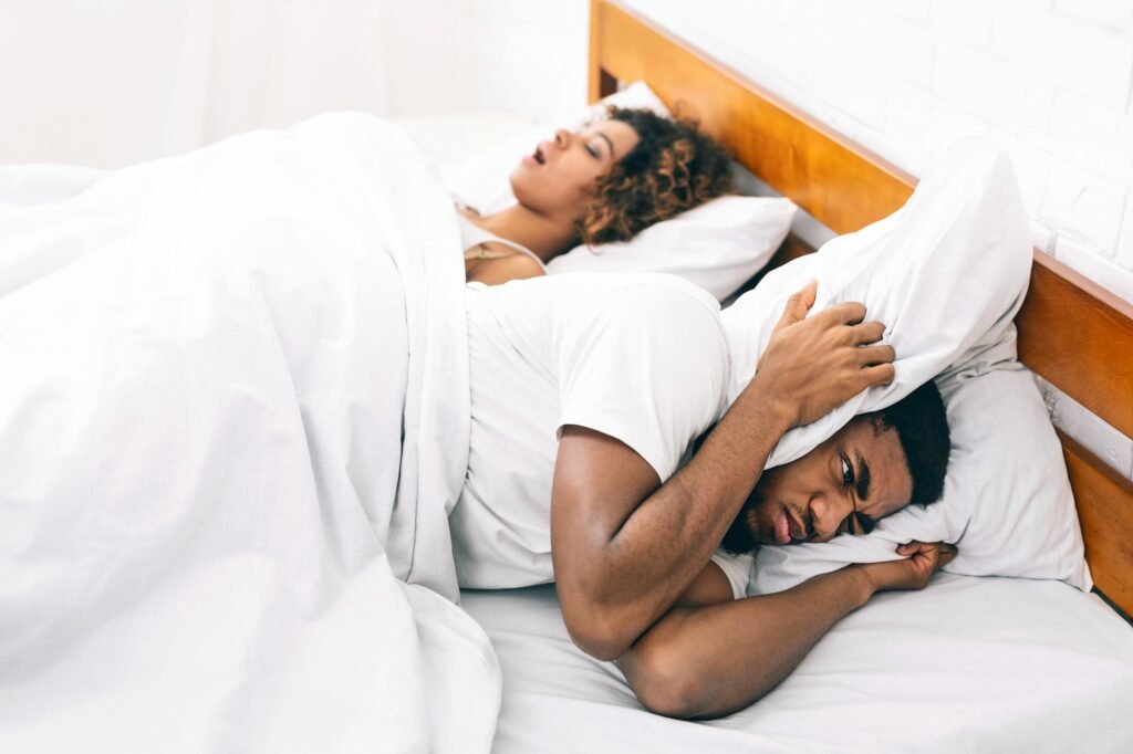 Tired and annoyed man of his girlfriend snoring