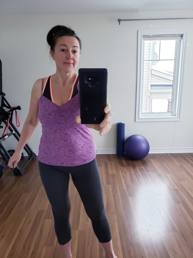 Woman in a sportswear making her selfie photo to record a progress in weight loss